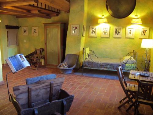 a living room with a bed and a table and chairs at Oasi Galbusera Bianca in Rovagnate
