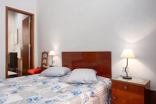 a bedroom with a bed with two pillows on it at Almada Guest House in Porto