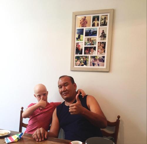 a man and a child sitting at a table at Guest House Hello in Kutaisi