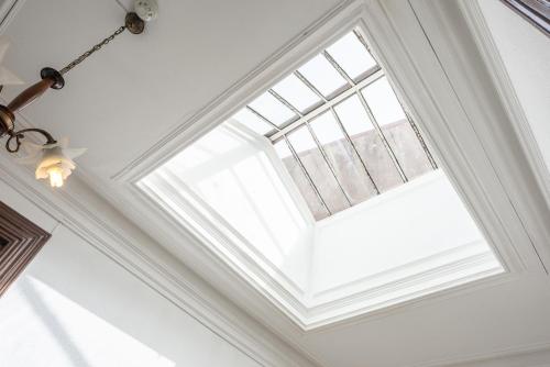 a skylight in a ceiling with a window at Almada Guest House in Porto