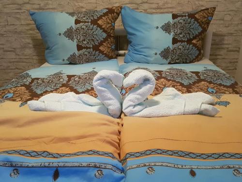 a bed with two white towels on it at Monteurwohnung Schinderhannes in Miehlen