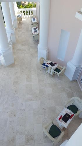 an image of a room with chairs and tables at Ocean West Boutique Hotel in Nassau