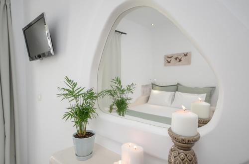 a bedroom with a bed and a mirror at Naxos Dream Oniro Studios - Adults Only in Naxos Chora
