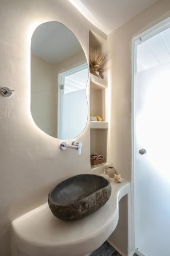 a bathroom with a stone sink and a mirror at Naxos Dream Oniro Studios - Adults Only in Naxos Chora