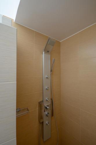 a shower stall in a bathroom with wooden walls at Naxos Dream Oniro Studios - Adults Only in Naxos Chora