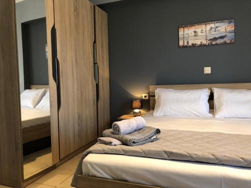 - une chambre avec un lit et un placard avec des serviettes dans l'établissement A for Argostoli, à Argostóli
