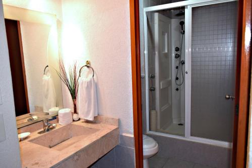 a bathroom with a sink and a toilet and a shower at Best Western Global Express in Veracruz