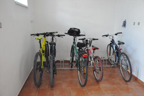 three bikes are lined up against a wall at Penzion Zuzana in Staré Splavy