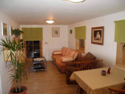 a living room with a couch and a table at Gästehaus Dorer Gerhard in Prägraten am Großvenediger