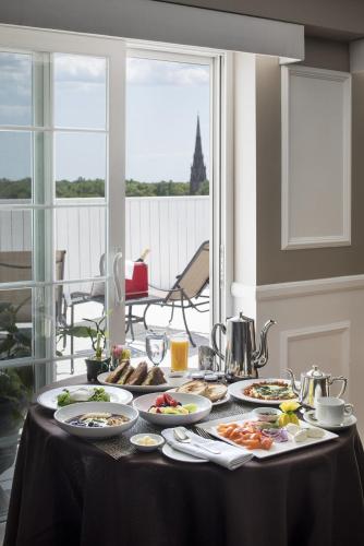 a table with plates of food on top of it at Garden City Hotel in Garden City
