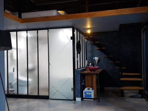 a hallway with a glass door and a staircase at Malu Hotel Suwon in Suwon