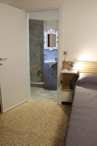 a bedroom with a bed and a bathroom with a sink at B & B Da Matilde in Bologna