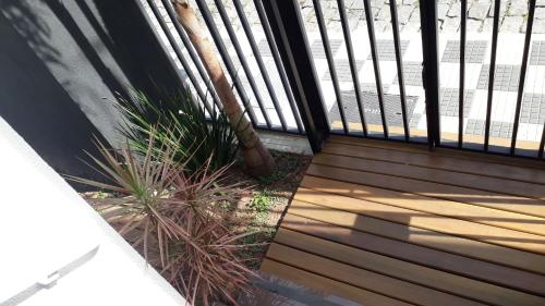 a porch with a fence and some plants at Antonia Haddad in Lorena