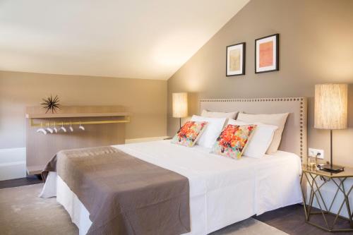 a bedroom with a large white bed with pillows at Gil Vicente - Charming Guesthouse in Porto