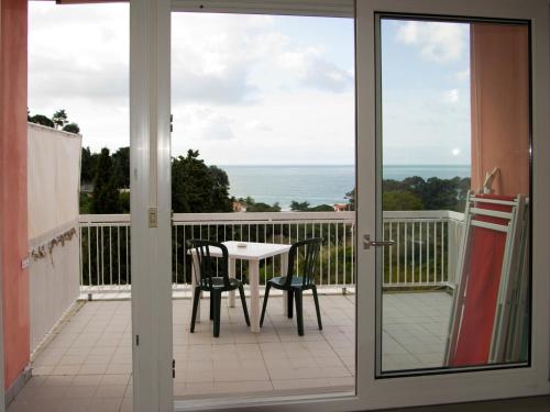 a patio door with a table and chairs on a balcony at Hotel Cristallo in Lerici