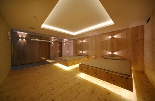 a room with two beds in a wood paneled room at Schönblick - Gurgl B&B in Obergurgl