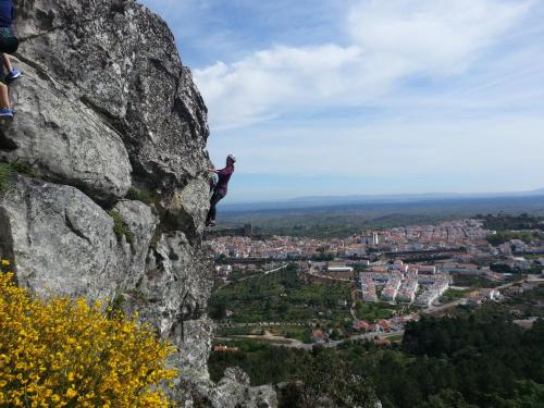 a person standing on a rock overlooking a city at Casa da Rua Nova in Castelo de Vide