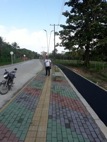 a man standing on the side of a road at Gran Muelle Hotel in San Bernardo del Viento