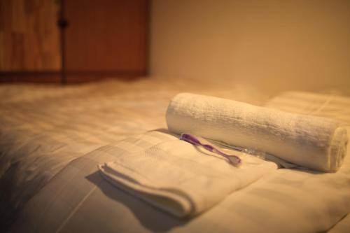 En eller flere senge i et værelse på Ngoc Tung Mini Hotel