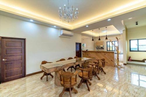 a dining room with a large table and chairs at Zhitian Heye in Chenggong