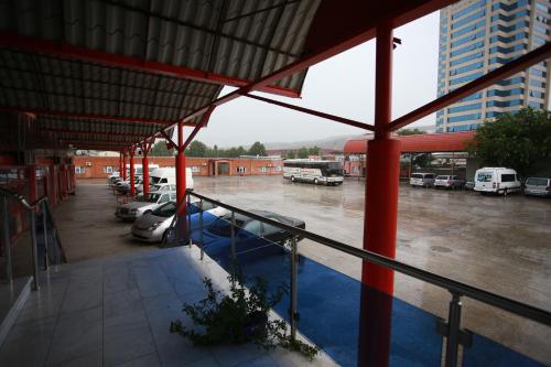 a bus station with buses parked in a parking lot at Hotel Okriba Tbilisi in Tbilisi City