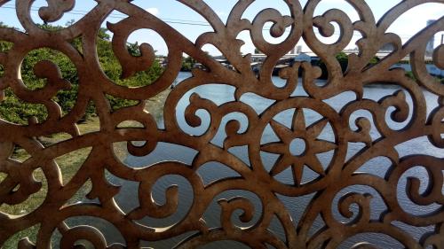 a close up of a metal fence with a window at Mangue Oranje Hostel - no bairro do Recife Antigo - Old Town in Recife