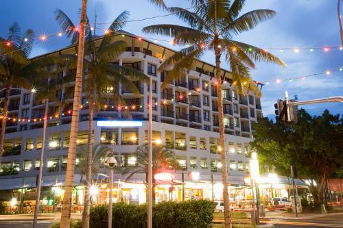 a large white building with christmas lights on it at Mantra Esplanade in Cairns