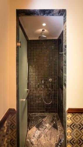 a shower with a glass door in a bathroom at La Siesta Hoi An Resort & Spa in Hoi An