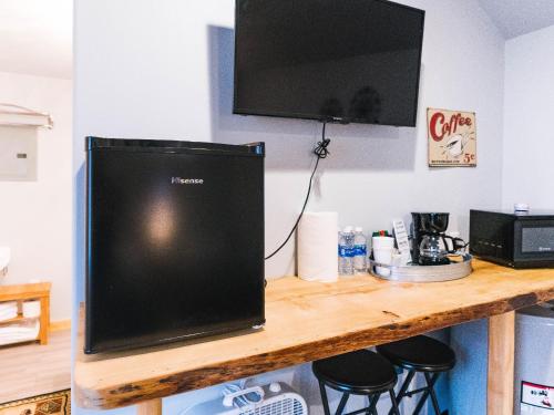 a television sitting on top of a wooden table at Cache Cabins in Sunshine