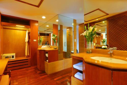 a bathroom with a sink and a large mirror at Nakamanda Resort and Spa- SHA Plus in Klong Muang Beach