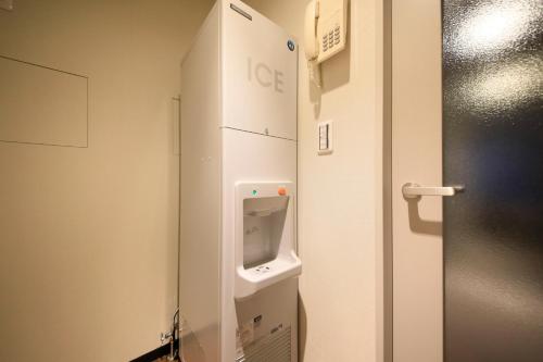 a bathroom with a urinal in a room at The Hedistar Hotel Kyoto Nijo Comic & Books in Kyoto