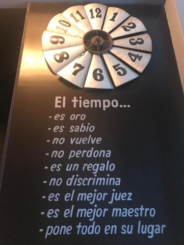 a wall clock with a poem on it at Sol-O-Cien Condo in Rosarito