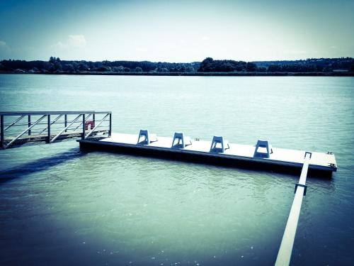 a dock with chairs on it in the water at Maison d'hôtes MIRADOUR in Labenne