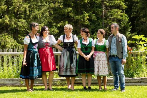 a group of people standing in the grass at Chalet Vites Mountain Hotel in Canazei