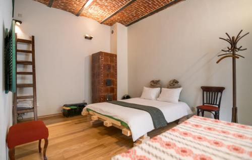 a bedroom with a bed and a table and chairs at Folkloric Loft-Ulița Românească in Sibiu