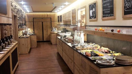 a large kitchen with a buffet of food at Alpenhotel Speckbacher Hof in Gnadenwald