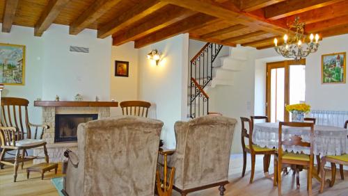 a dining room with a table and chairs and a fireplace at Casa De Pol Exclusive Lake View by Gardadomusmea in Tremosine Sul Garda