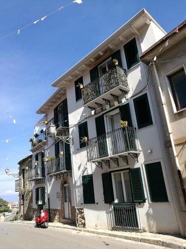 a scooter parked in front of a white building at La Via del Carretto B&B in Capri Leone