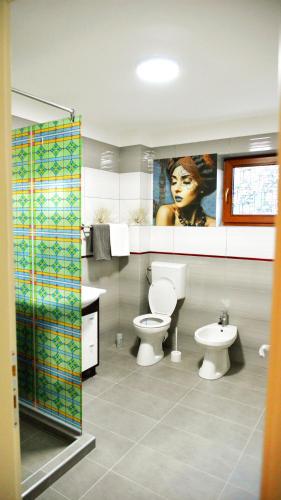 a bathroom with a toilet and a sink at Elena Haus in Cluj-Napoca