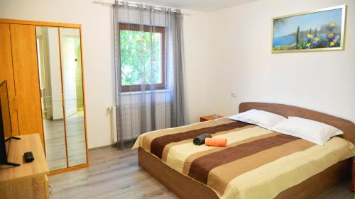 a bedroom with a bed and a large window at Elena Haus in Cluj-Napoca
