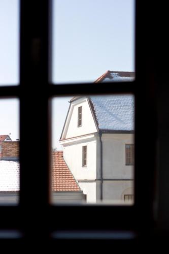 a view from a window of a white building at Hotel Dvur Hoffmeister in Velké Číčovice