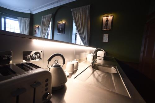 a bathroom with a sink and a mirror at Cupar Burgh Chambers in Cupar