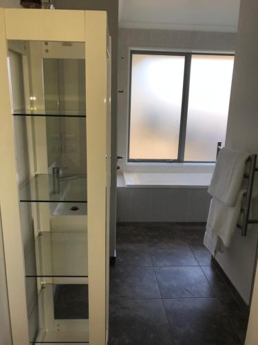 a bathroom with a sink and a window in a room at Memorial holiday home in Christchurch