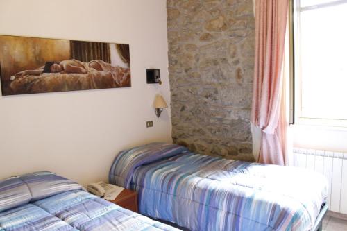 Postel nebo postele na pokoji v ubytování Albergo Elisa
