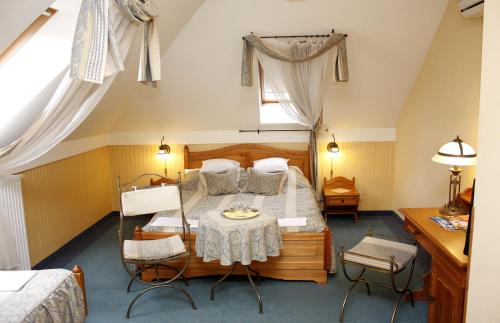 A bed or beds in a room at Lévay Villa Hotel