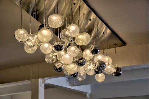 a chandelier with many spheres hanging from a staircase at The Moon Boutique Hotel & Spa in Florence