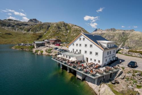 an aerial view of a restaurant on a dock in the water at Hotel Grimsel Passhöhe in Oberwald