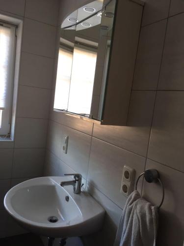 a bathroom with a sink and a mirror at FeWo Haase in Westerstede