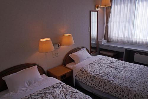 A bed or beds in a room at Pension Entre - deux - Mers