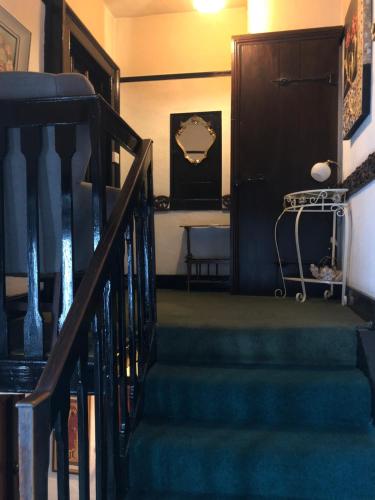 
a hallway with stairs leading up to a staircase at Ely Guest House in Ely
